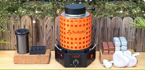 ToAuto electric melting furnace displaying 1200°C with a crucible and ingot molds beside it
