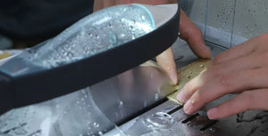 Close-up of the ToAuto smart metal cutting saw's liquid cooling spray in action while cutting a metal workpiece